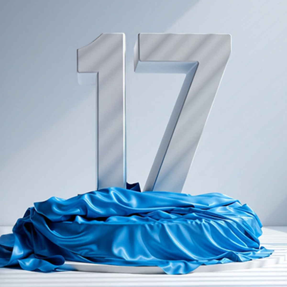 The number 17 on a podium in a white room, with blue cloth wrapped around the bottom of the podium