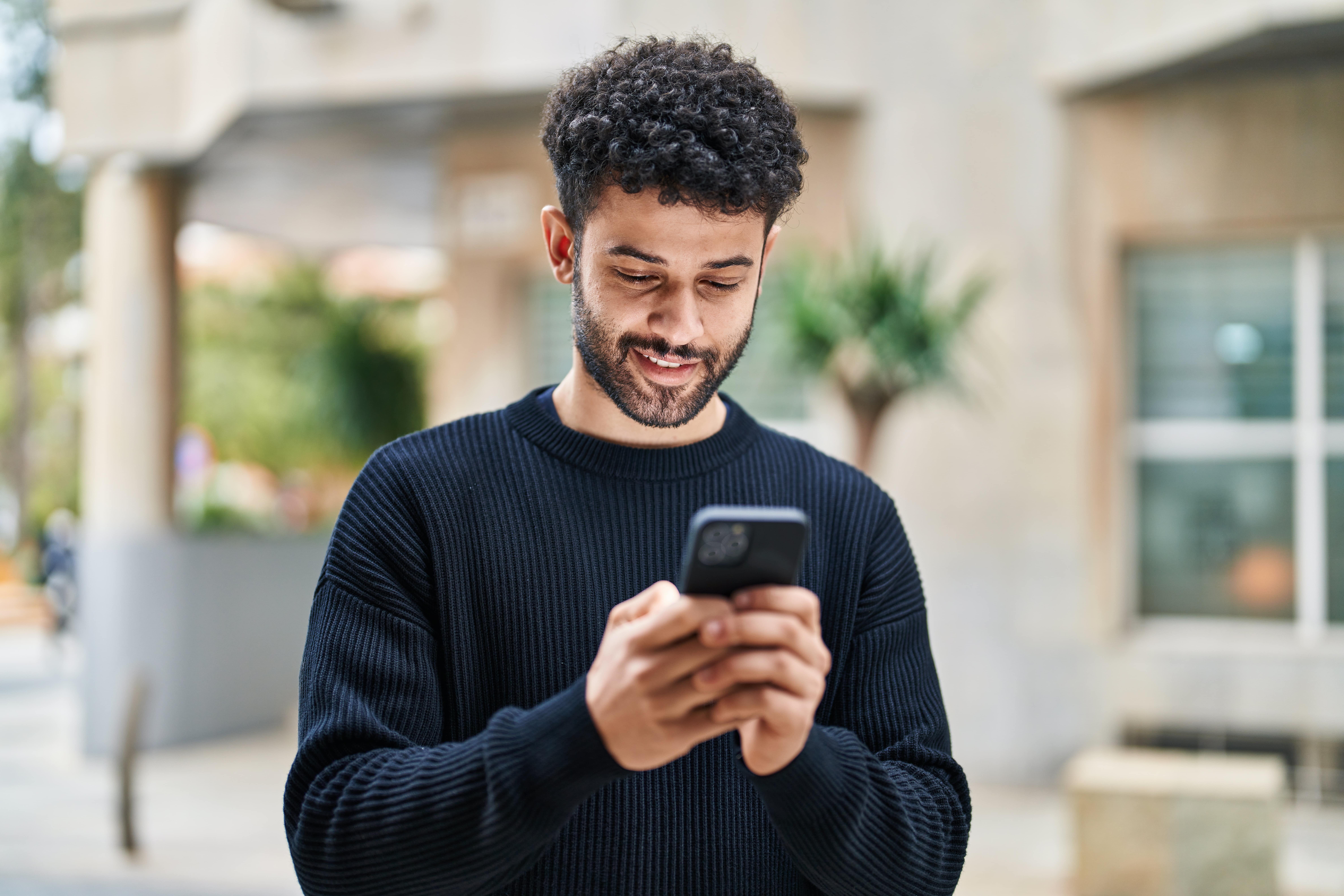 A person scrolling on a smartphone device.
