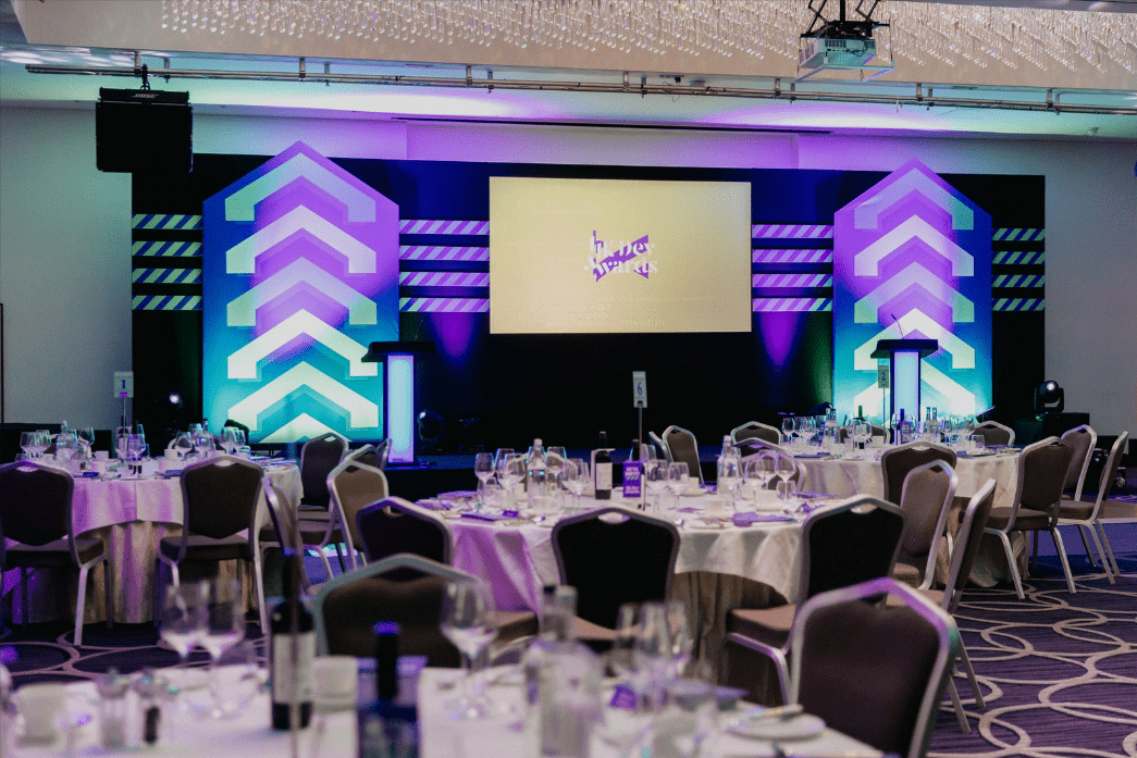 The UK Dev Awards stage and tables in the audience.