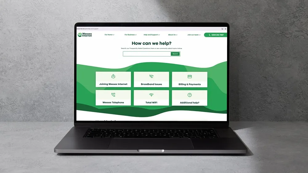 Wessex Internet's help page on a laptop, with a search field and six support topic tiles.