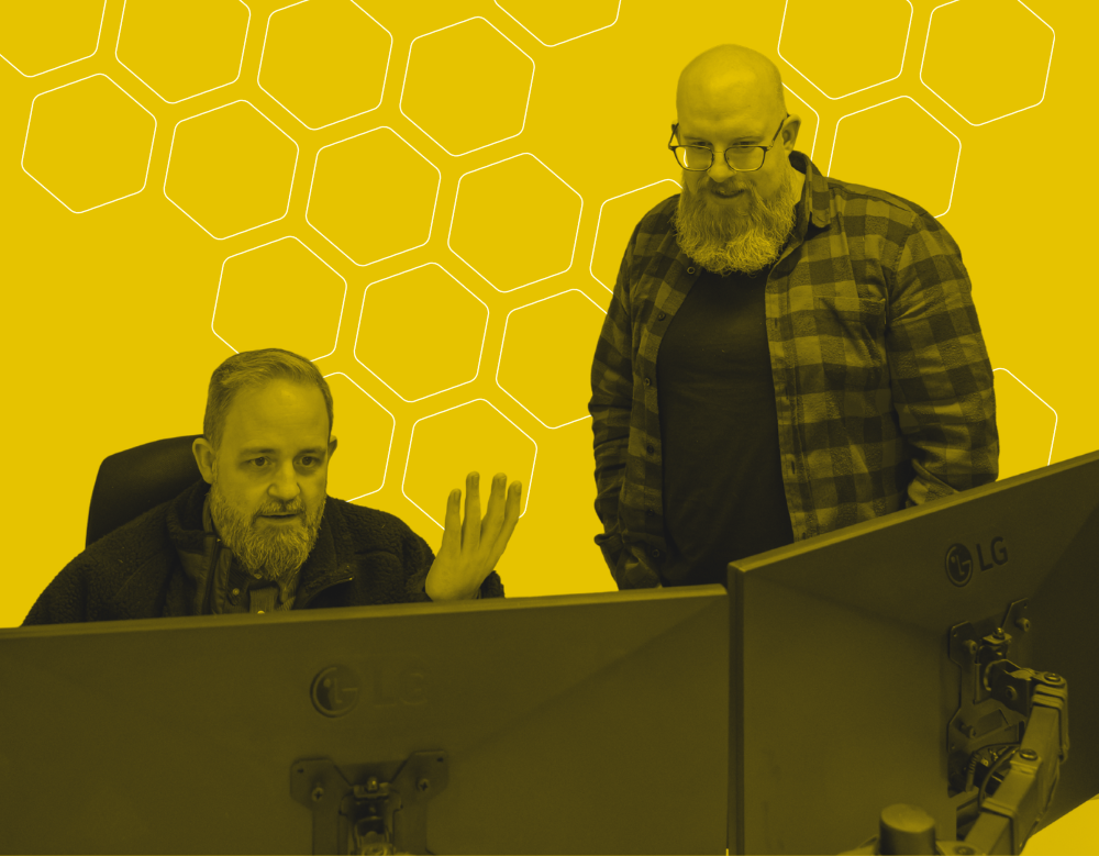 A black and yellow graphic of two Cold Banana employees working together on bug fixes