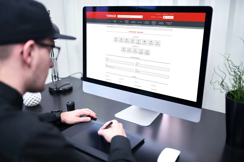 TIMCO's My Account interface on a desktop monitor, with account navigation and personal detail fields.