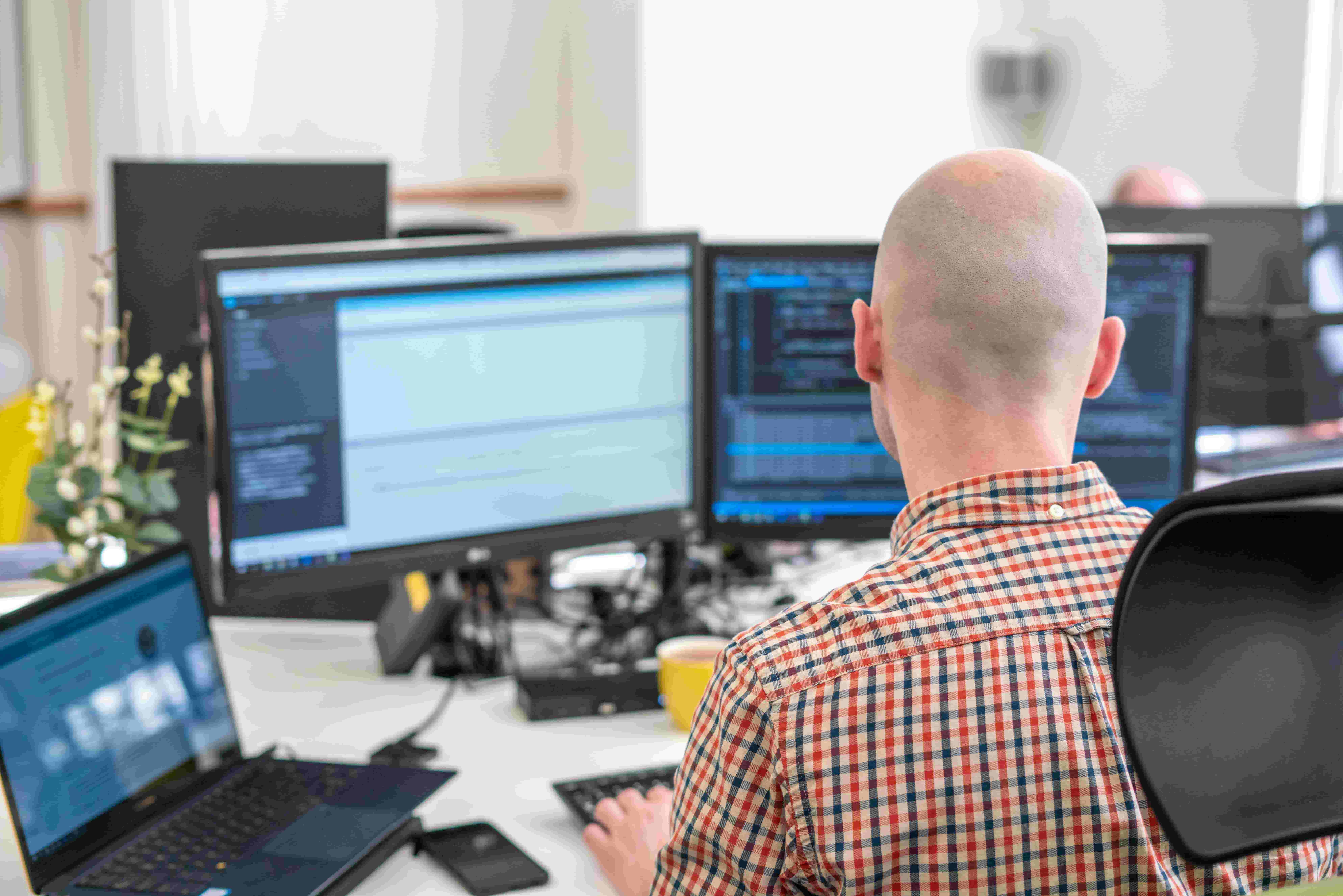 A man coding on a computer screen.