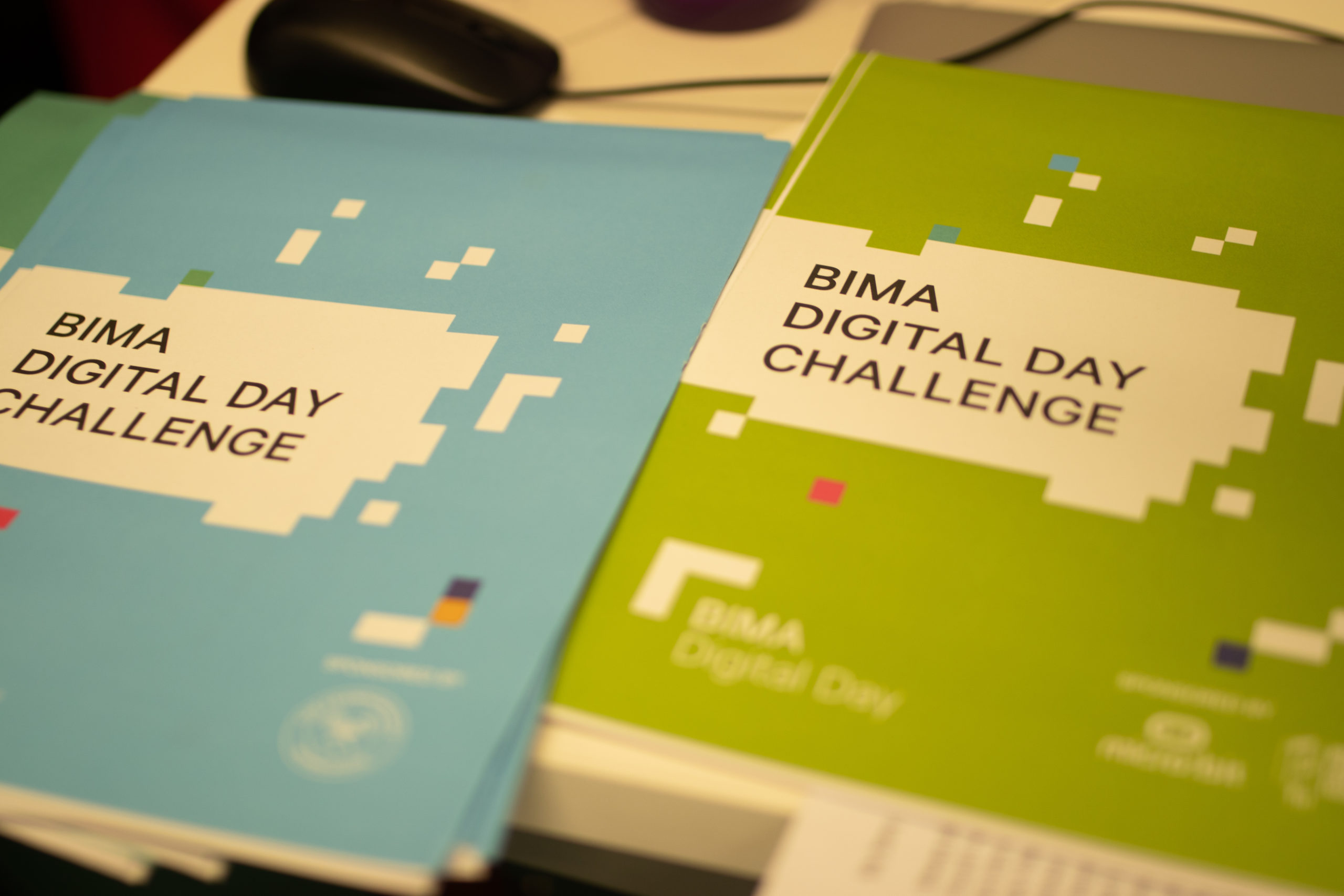 BIMA Digital Day Challenge Booklets, the left in light blue and the right in lime green.