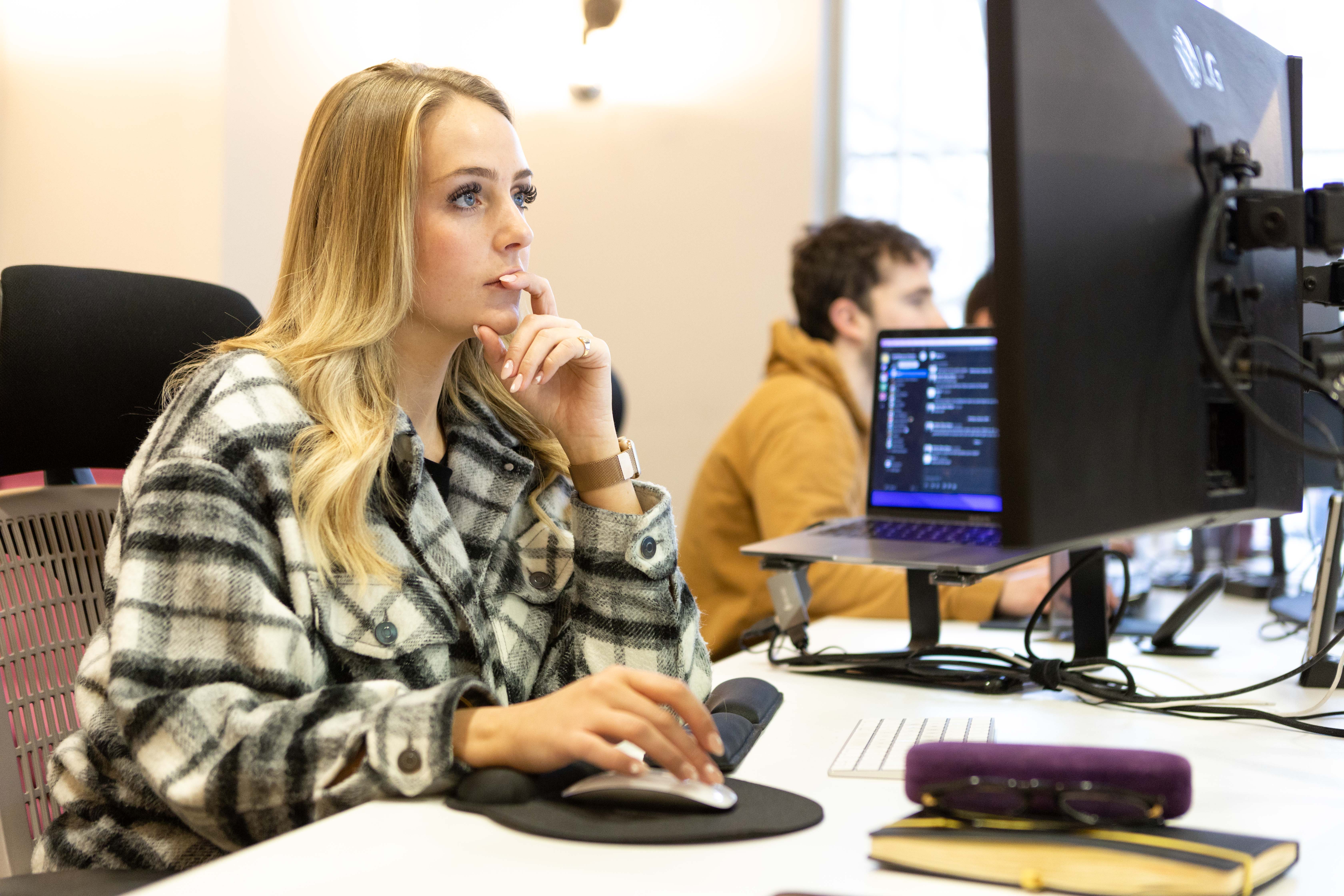 Cold Banana employee working at a problem on a computer.