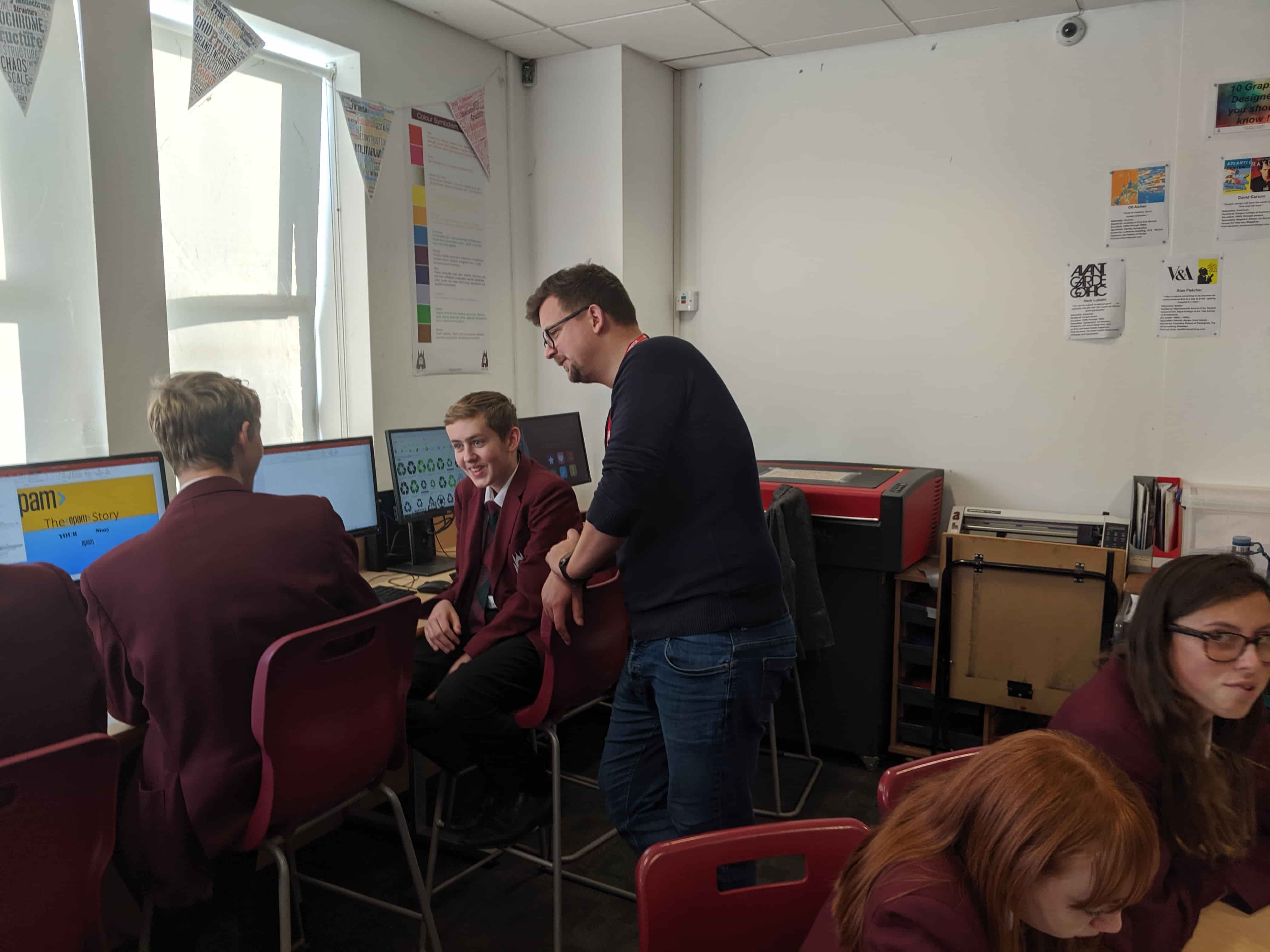 A Cold Banana employee tutoring school children at computers during BIMA Digital Day 2019.