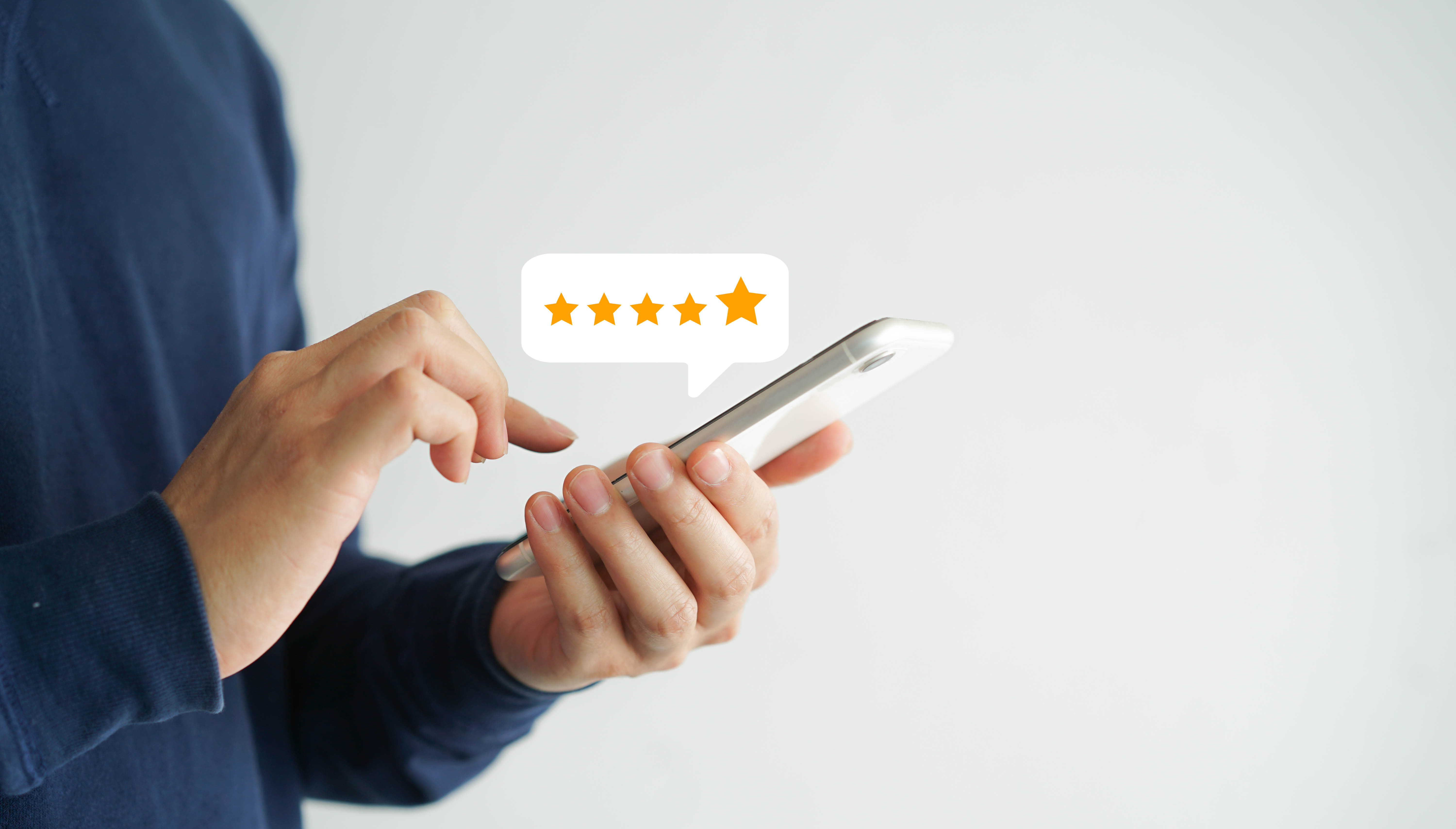 A person giving a 5 star rating on their smartphone device