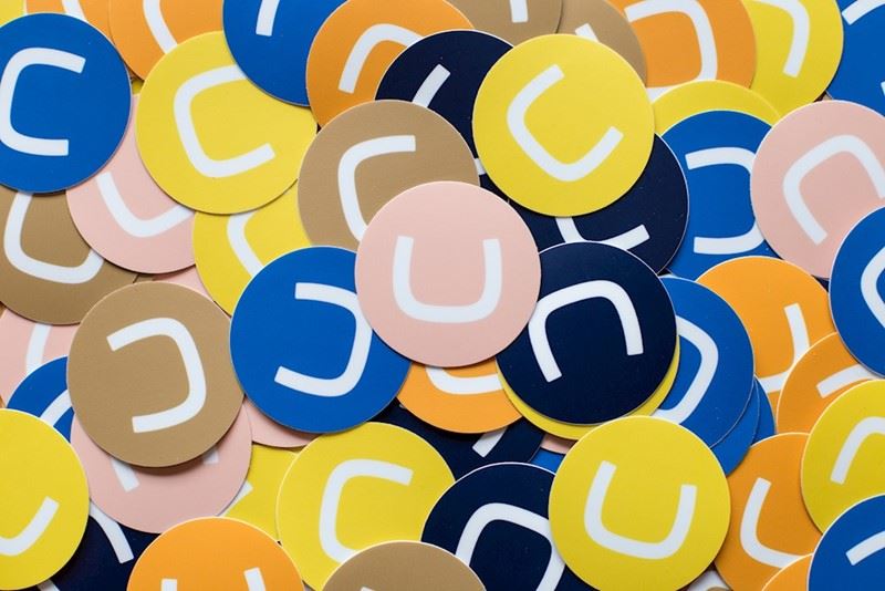 Dozens of Umbraco Stickers in yellow, pink, brown, blue, orange, navy and gold.