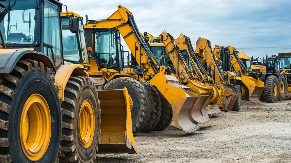 Yellow industrial diggers lined up in a row