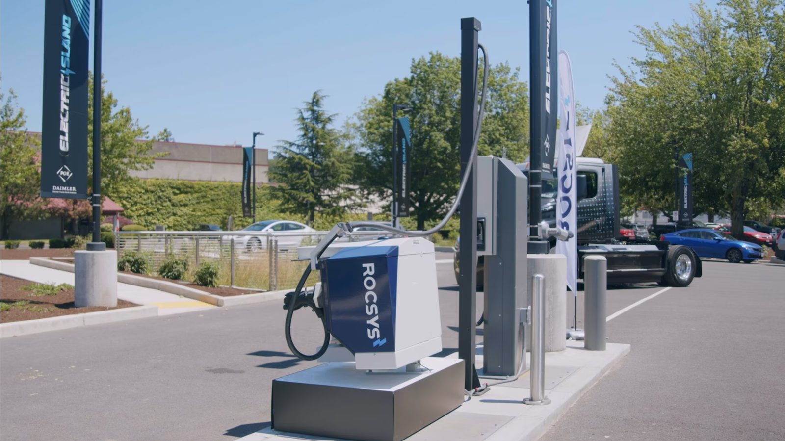 A Rocsys automated charging unit beside an electric truck